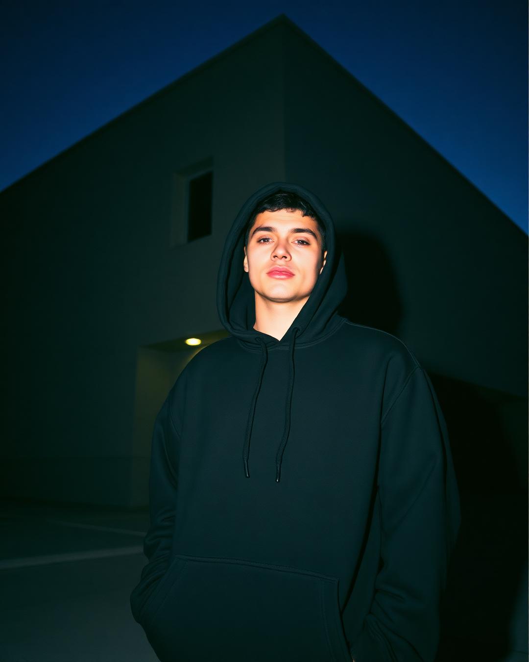 Model wearing branded oversized black hoodie